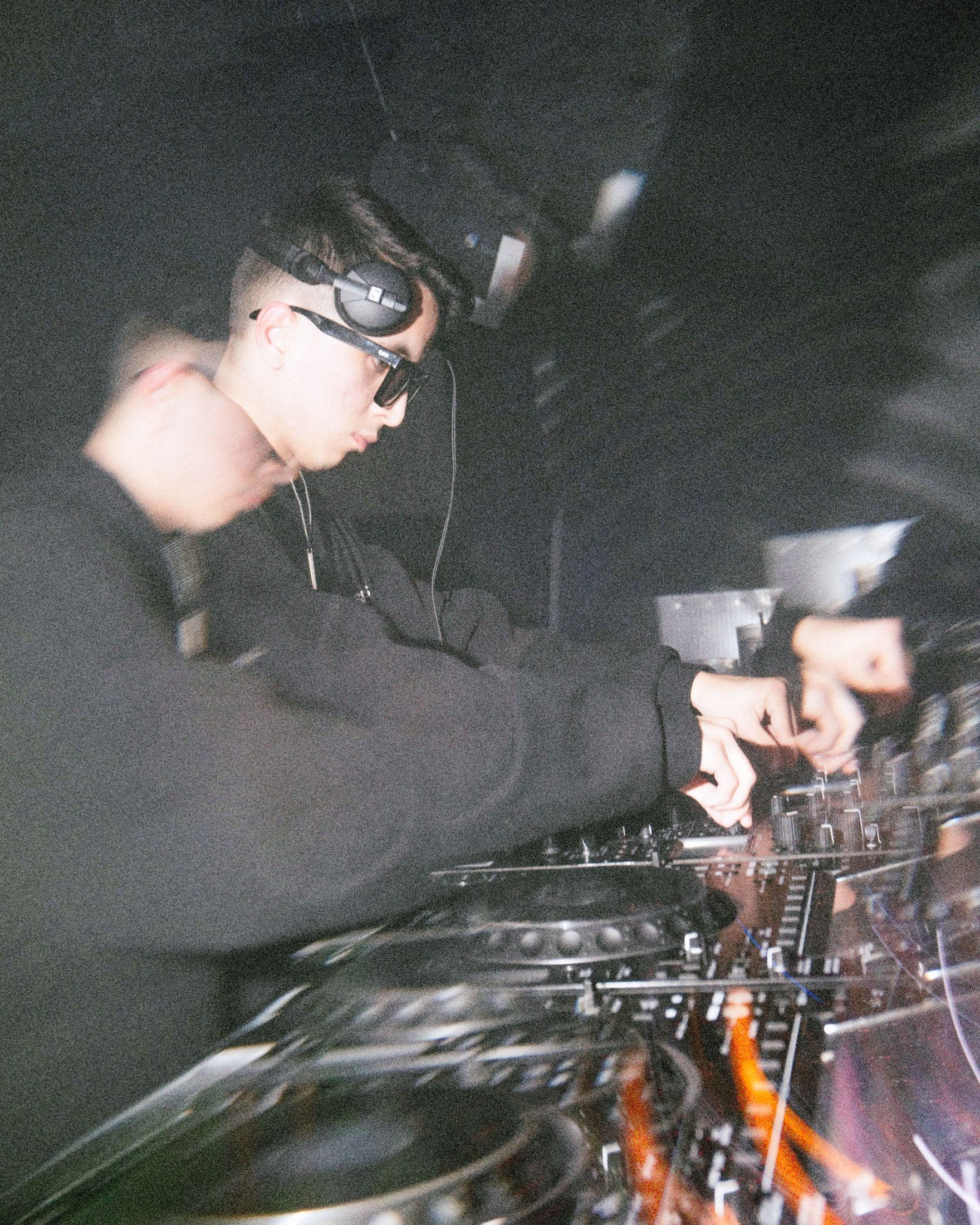 Kike Moreno leaning over the CDJs mid-mix