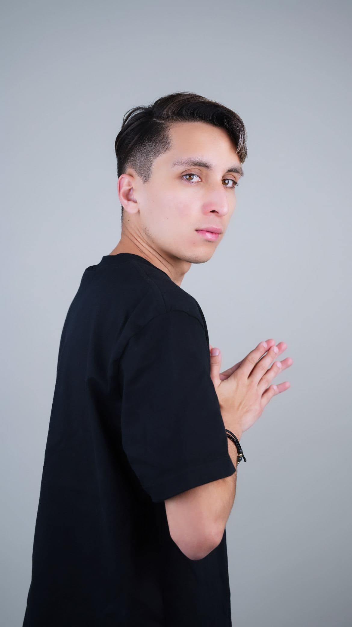 Kike Moreno photographed against a light grey studio backdrop